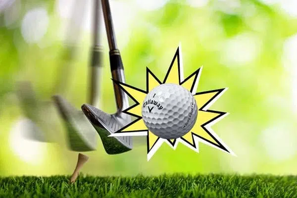 Golfer compressing a golf ball with an iron