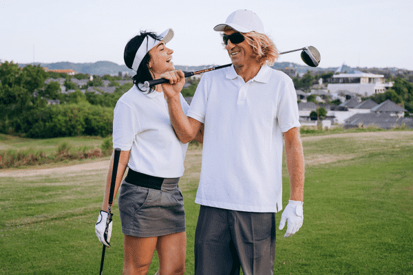 Male and female golfer having fun
