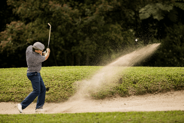 Golfer hitting a bunker shot